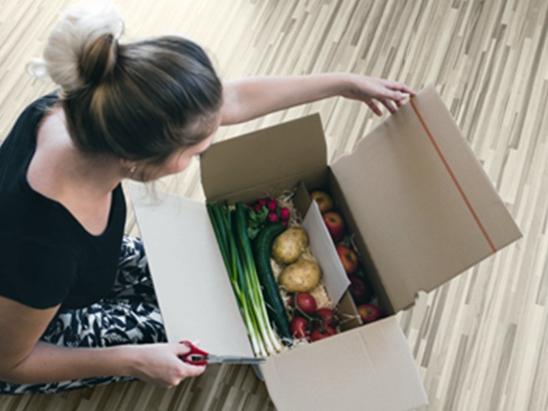 Women unpacking grocery food items