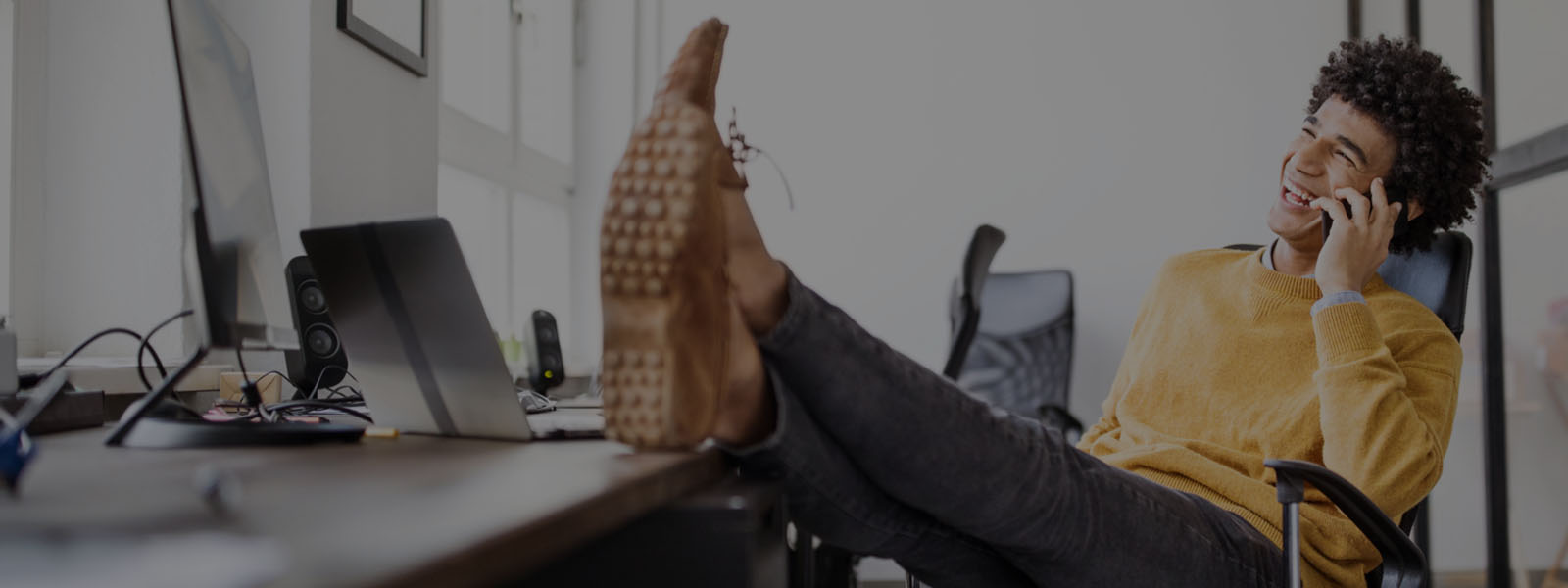 A man talking on the phone while working in the office