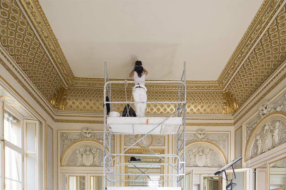 A person painting a roof