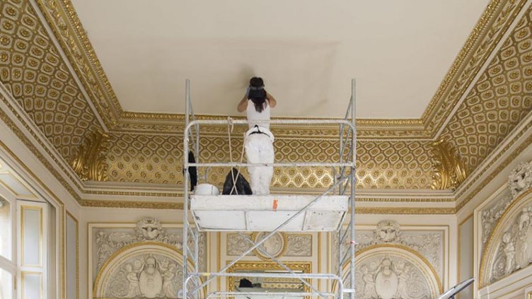 A person painting a roof