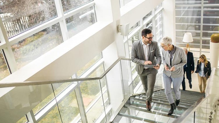 Office colleagues walking in stairs