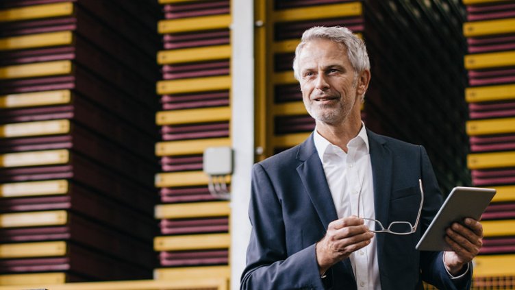 Un homme avec une tablette à la main présente les transformations de la Supply Chain