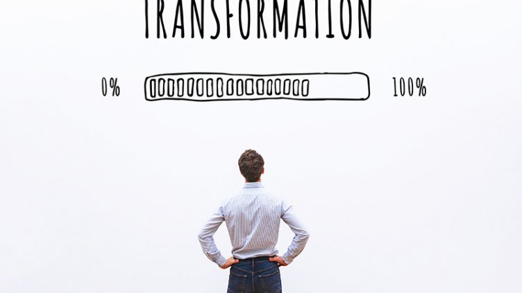 A corporate man watching the progress of a loading bar titled transformation