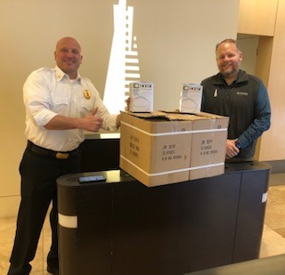 Fire department officer posing with a cardboardbox