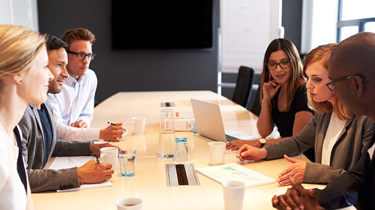 Group of young executives holding a work meeting in a conference room