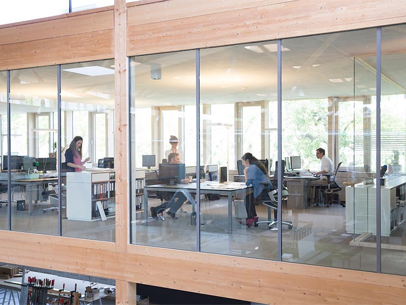 Exterior view of employees are working inside the real estate office