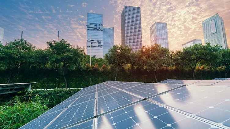Solar panels and commercial buildings with a sunset backdrop