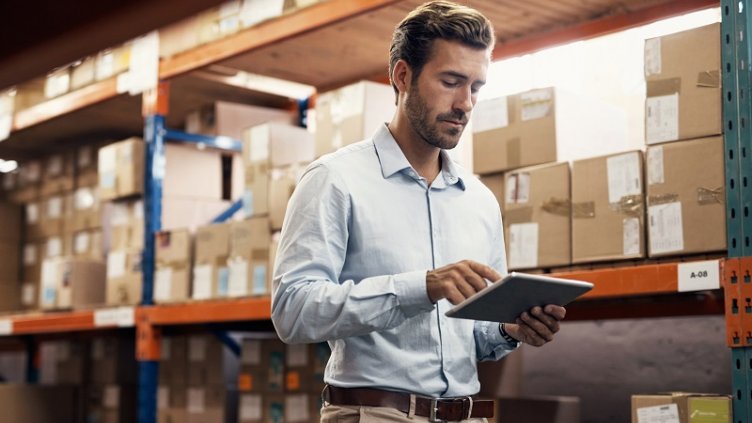 Shot of a young man using a digital tablet while working in a warehouse