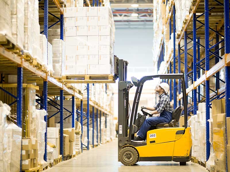 Warehouse driver operating forklift