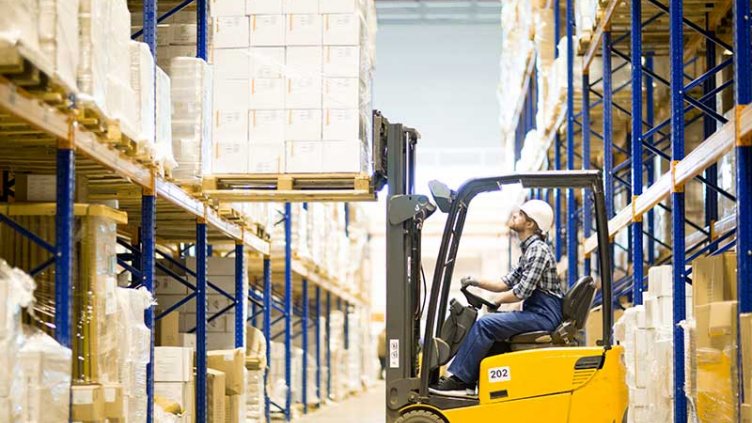 Warehouse driver operating forklift