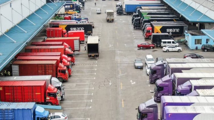 Logistics trucks outside a warehouse